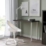 Modern home office with LINNMON desk, chair, lamp, and wall art.