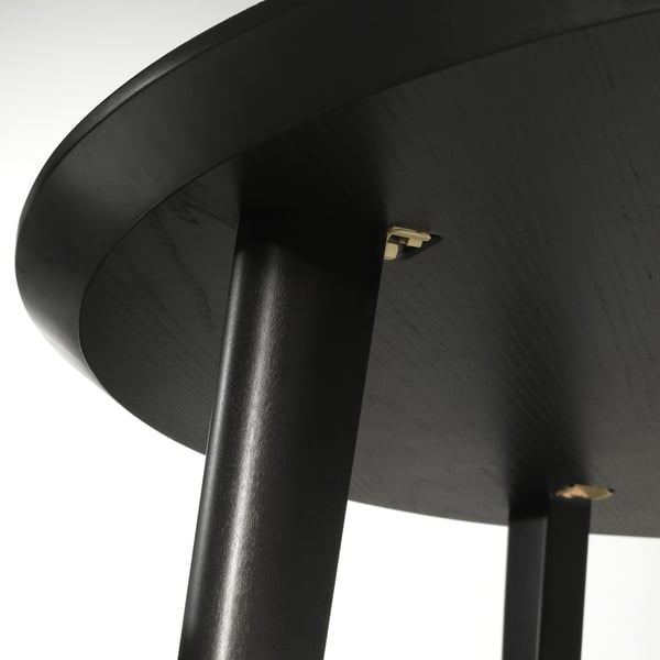 Stylish black dining table angled view, showcasing smooth wooden surface and sturdy legs.