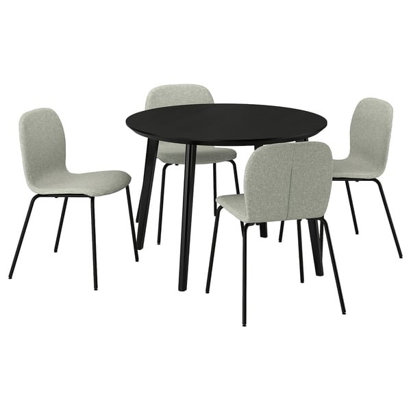Modern round black dining table with four light grey upholstered chairs. Sleek design for cozy dining.