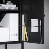 Black cabinet with open door showing letter and ruler organizer.