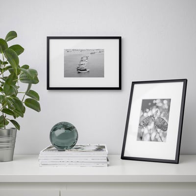 Black LOMVIKEN photo frame with grey mat, rectangular, sleek design.