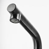 Modern metallic faucet with sleek, curved spout and textured, honeycomb-patterned nozzle.