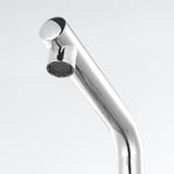 Chrome faucet with curved spout, reflective finish, on white background.