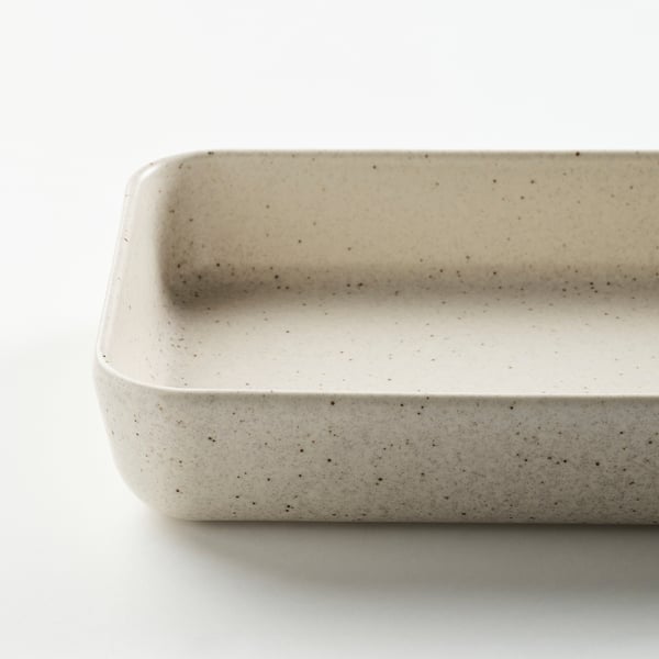 Small white speckled dish, shallow, dishwasher-safe.