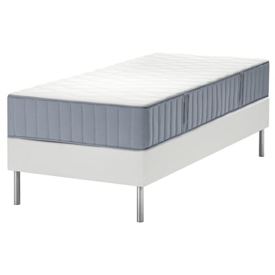 A modern white bed with gray mattresses, stainless steel legs, flat slats, and comfort zones.