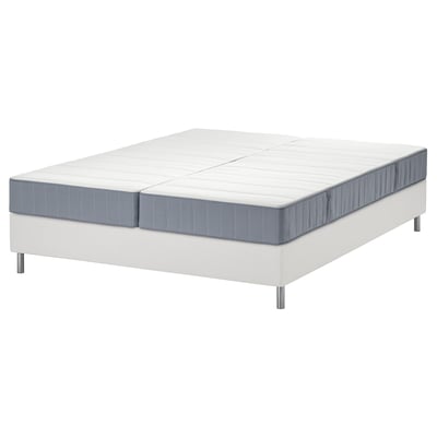 White LYNGÖR bed with split grey mattress on flat slats.