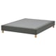 Grey upholstered bed base on wooden legs, rectangular shape, simple design.