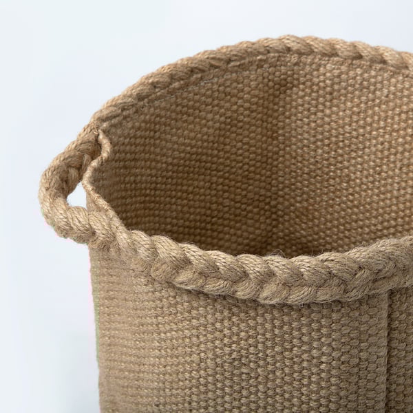 Handwoven jute basket with sturdy handles, showcasing natural texture and craftsmanship.