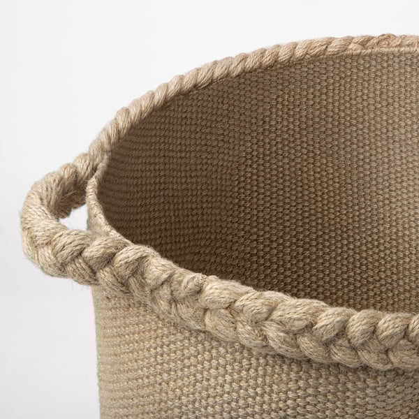 Jute basket with braided handles, neatly woven texture, durable and natural; ideal for home storage.