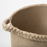 Jute basket with braided handles, neatly woven texture, durable and natural; ideal for home storage.