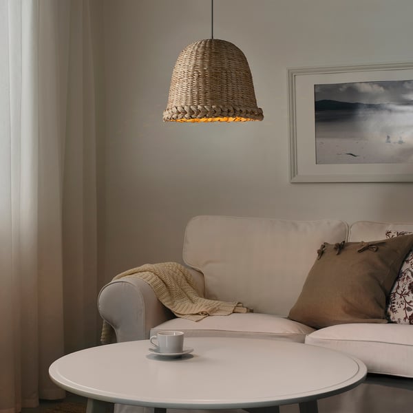 Cozy living room with banana fiber lampshade, sofa, and pillows.
