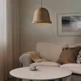Cozy living room with banana fiber lampshade, sofa, and pillows.