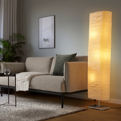 Cozy living room with MAGNARP lamp beside beige sofa, soft light.