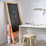 Childs art station with chalk and whiteboard easel, desk, stool, and supplies.