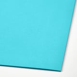 Close-up of smooth, high-quality turquoise paper, ideal for kids crafts.