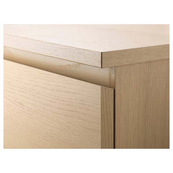 Close-up of a wooden dresser, showing fine craftsmanship and smooth edges.