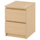 An ikea MALM light brown wooden nightstand with smooth drawers.