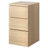 An ikea MALM light oak 3-drawer chest. It a sleek, rectangular design with smooth, minimalist fronts, and is made from oak veneer and particleboard.