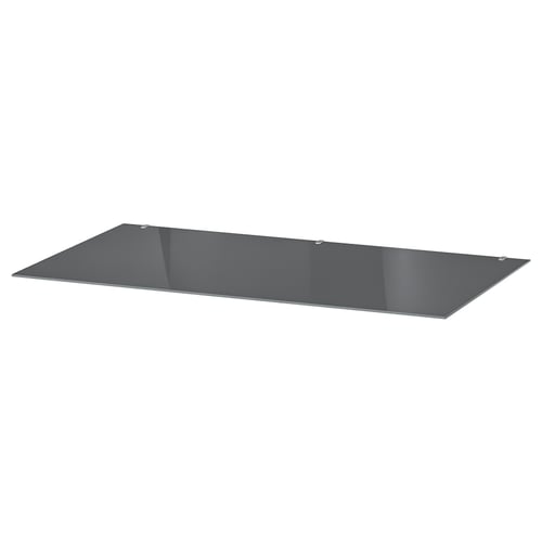 A sleek, rectangular grey glass shelf. Its flat with tempered edges, perfect for modern furniture.