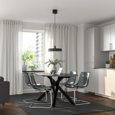 Modern dining setup with MARIEDAMM table and chairs, gray curtains, window.