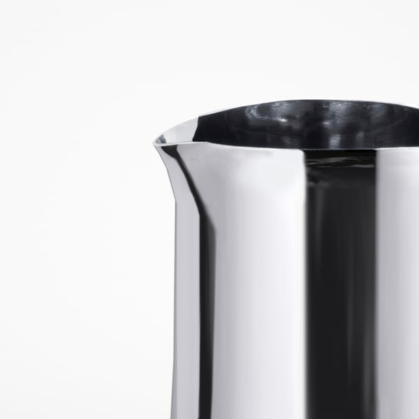 Close-up of sleek, polished stainless steel jug, showcasing its smooth surface and refined quality.