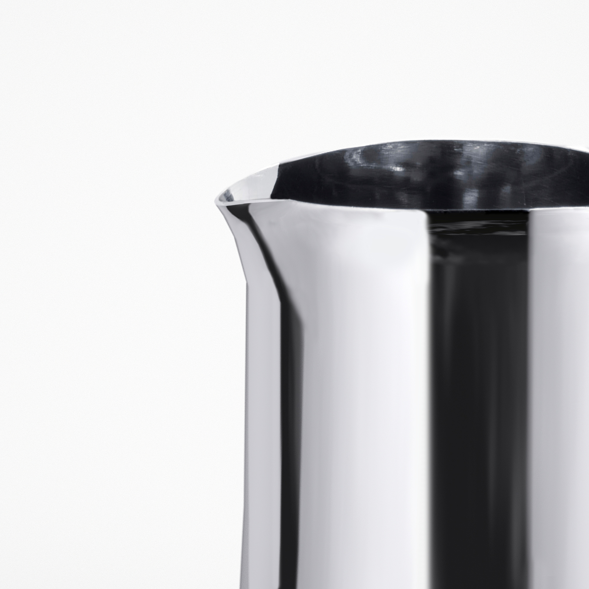 Close-up of sleek, polished stainless steel jug, showcasing its smooth surface and refined quality.