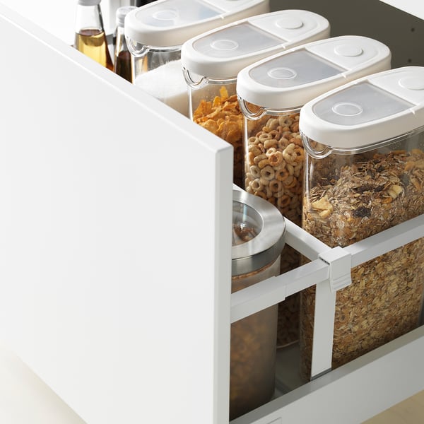 Open kitchen drawer with clear cereal containers; modern design with quiet-close feature.