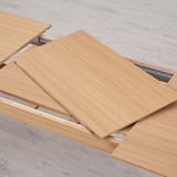 Wooden table leaves with metal rails, showing extension mechanism for table expansion.