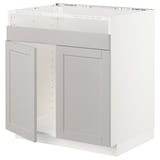 A white METOD kitchen cabinet with light grey lerhyttan doors featuring beveled edges and a traditional design.