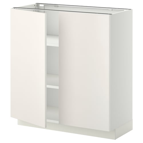 A white METOD kitchen cabinet with two open doors, showcasing inner shelves.