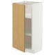 A white METOD kitchen cabinet with a single light oak door open, revealing two shelves.
