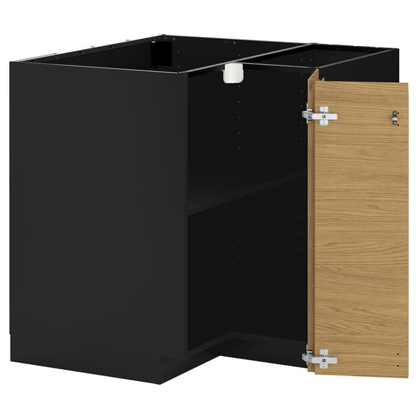 A black and oak ikea METOD kitchen unit with an open door.