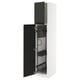 A white METOD kitchen cabinet with black upplöv doors open, revealing storage and organizers.