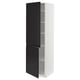 A tall, white cabinet with black doors. One door is open, revealing interior shelves. Modern design with matte black handles.