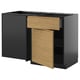 This image shows a modern, minimalist kitchen unit with a black frame and light wood-grain drawers, featuring integrated handles.