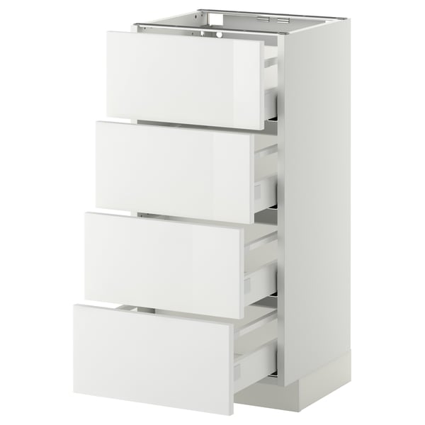 Displays a white METOD kitchen cabinet with multiple pull-out drawers, featuring a sleek, modern design with smooth surfaces and silver handles.