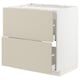 METOD kitchen cabinet in beige with smooth fronts, two bottom drawers partially open.