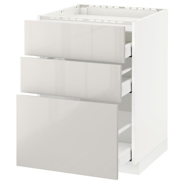 A white METOD kitchen unit with three drawers and a top shelf. The unit a modern, high-gloss finish.