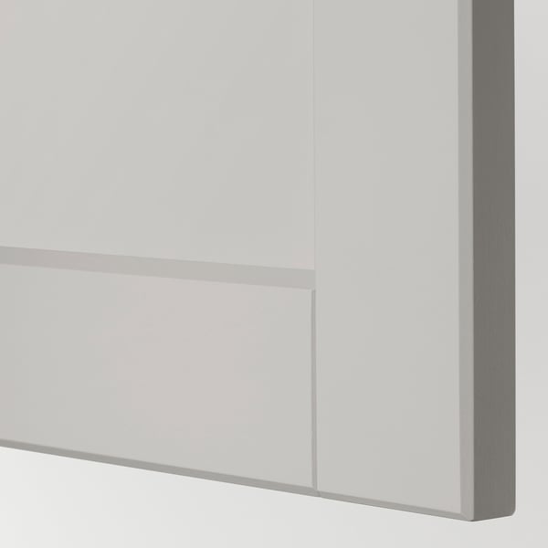 Close-up of modern kitchen drawer with sleek, smooth light grey finish and beveled edges.