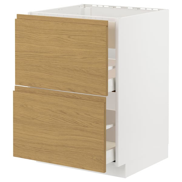 A minimalist kitchen unit in white and light oak. It two drawers with integrated handles and a sleek design. The unit is part of the METOD system.