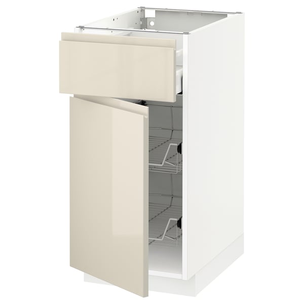 Modern kitchen cabinet with sleek beige high-gloss finish, open door and drawer, wire racks visible inside.