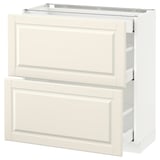 A white METOD kitchen cabinet with off-white bodbyn drawers featuring beveled edges.