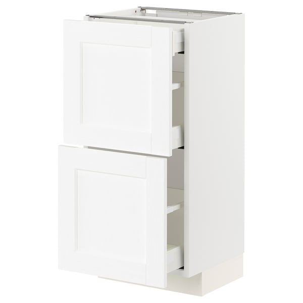 White METOD kitchen cabinet with two doors and internal shelves. Modern, rectangular design with subtle wood grain texture.