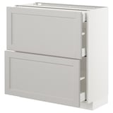 A white METOD kitchen cabinet unit with two drawers and a door, featuring a classic design with bevelled edges.