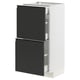 Modern white kitchen cabinet with sleek black drawers, minimalist handles, and integrated design.