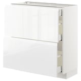 Modern white METOD kitchen cabinet with sleek, handle-less design and pull-out drawers.