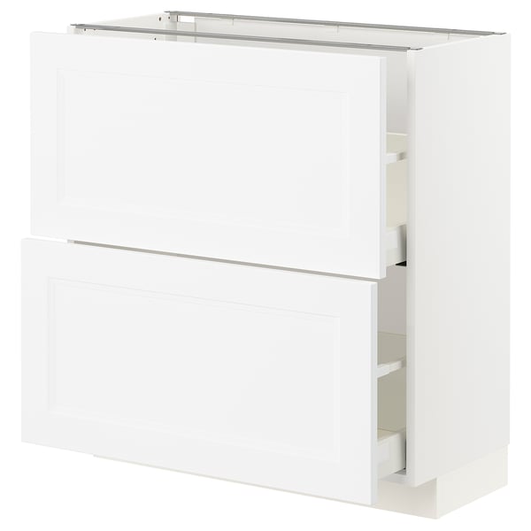 White METOD kitchen cabinet. Two large doors, one open revealing shelves. Modern, rectangular design.
