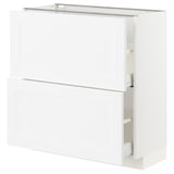 White METOD kitchen cabinet. Two large doors, one open revealing shelves. Modern, rectangular design.