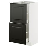 A white METOD kitchen cabinet with black bodbyn fronts, featuring two drawers and a cabinet door.