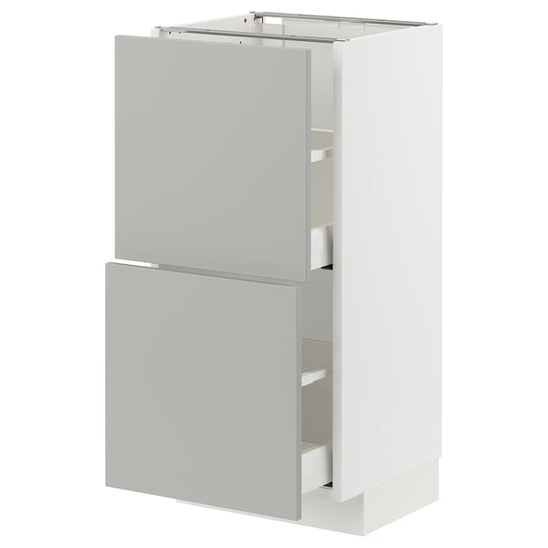 Modern white kitchen cabinet with light grey drawers, sleek and minimalist design.